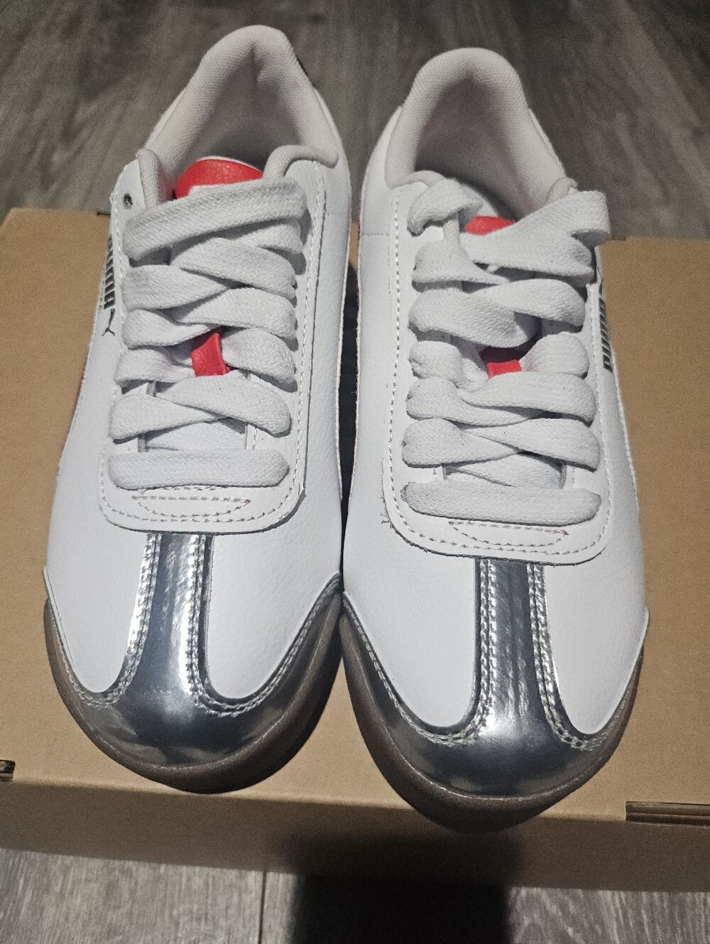 PUMA White Sneakers with Metallic Silver Trim and Red Tongue Accent